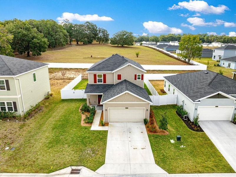 Front exterior of a new home in Millwood: Millwood Estates - The Enclave, Ocala, FL, highlighting curb appeal (Image 26). Front exterior of a new home in Millwood: Millwood Estates - The Enclave, Ocala, FL, highlighting curb appeal (Image 26).