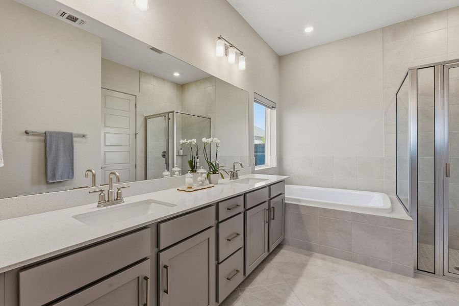 Bathroom with a shower stall, double vanity, a bath, and recessed lighting Bathroom with a shower stall, double vanity, a bath, and recessed lighting