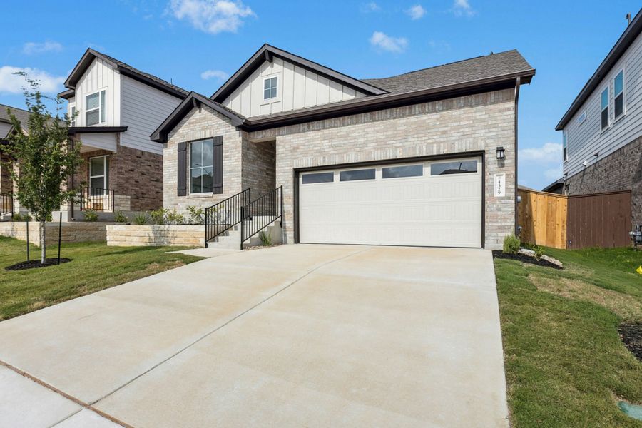 Front exterior of a new home in University Heights, Round Rock, TX, highlighting curb appeal (Image 16).