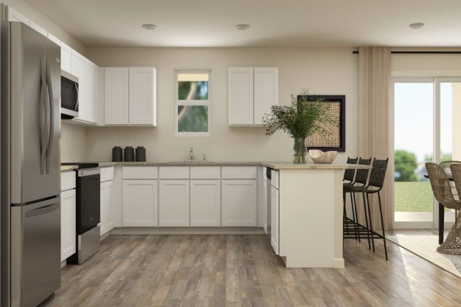 A kitchen with white cabinets.