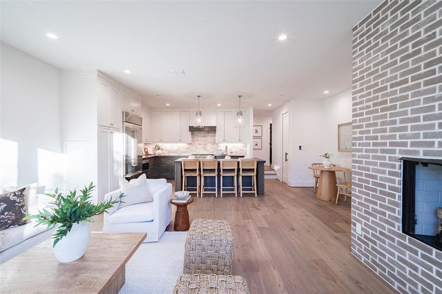 Living room featuring light wood-type flooring and a fireplace