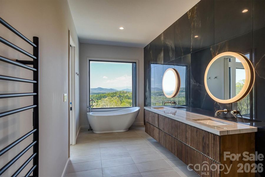 Primary bath has double sinks and soaking tub