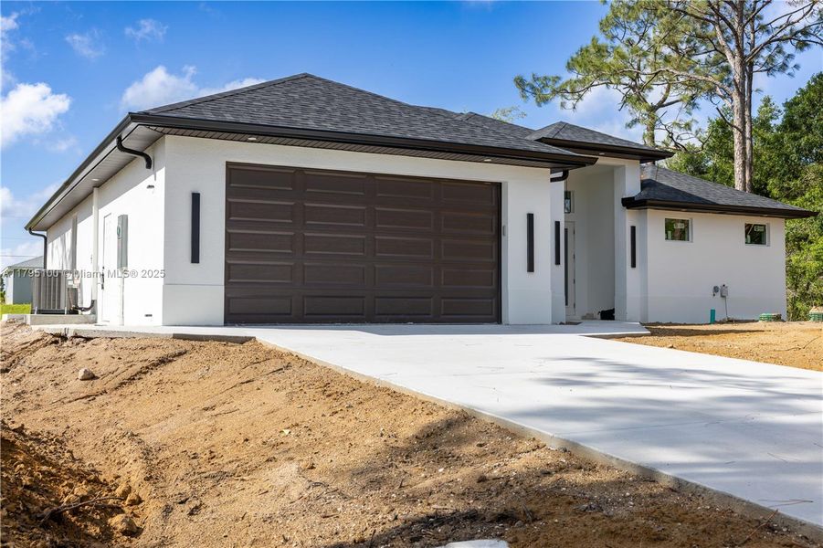 Front exterior of a new home in , Lehigh Acres, FL, highlighting curb appeal (Image 16).