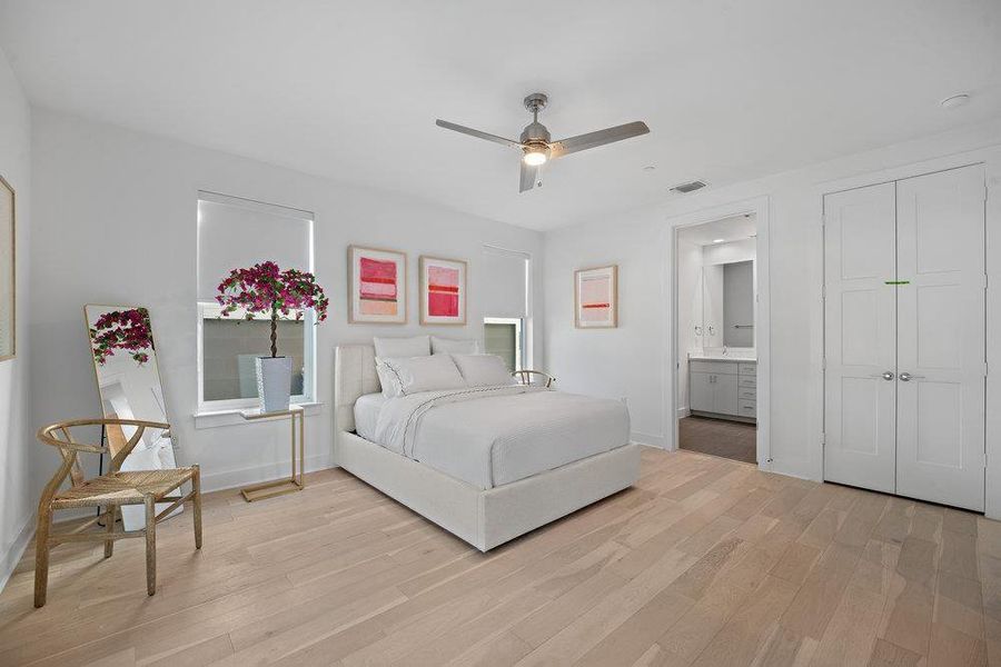 Bedroom featuring light wood-style flooring, ceiling fan, and a closet Bedroom featuring light wood-style flooring, ceiling fan, and a closet