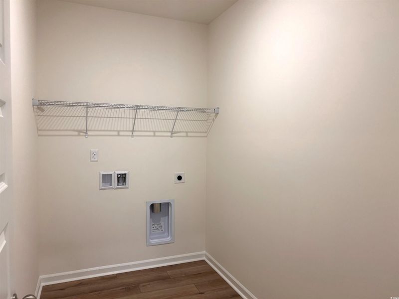 Washroom with dark wood finished floors, electric dryer hookup, and hookup for a washing machine