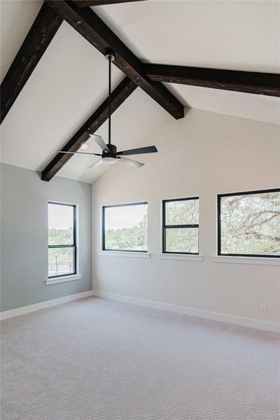 Empty room with light carpet, high vaulted ceiling, ceiling fan, and beamed ceiling