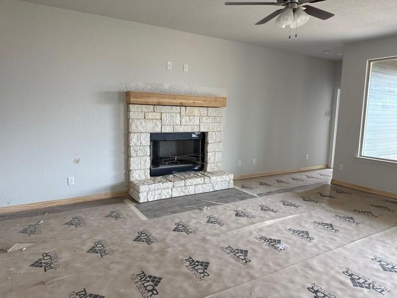 Stone-clad fireplace with a wood mantel