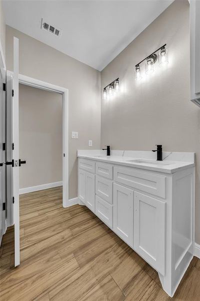 Bathroom with wood finished floors and double vanity Bathroom with wood finished floors and double vanity