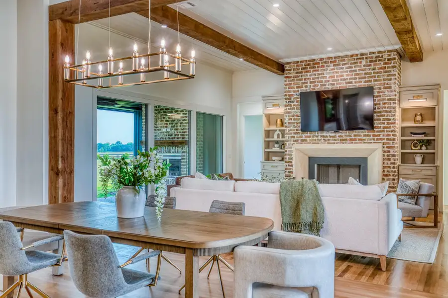 Dining room featuring a fireplace, wood finished floors, recessed lighting, a chandelier, and a wooden ceiling with exposed beams Dining room featuring a fireplace, wood finished floors, recessed lighting, a chandelier, and a wooden ceiling with exposed beams