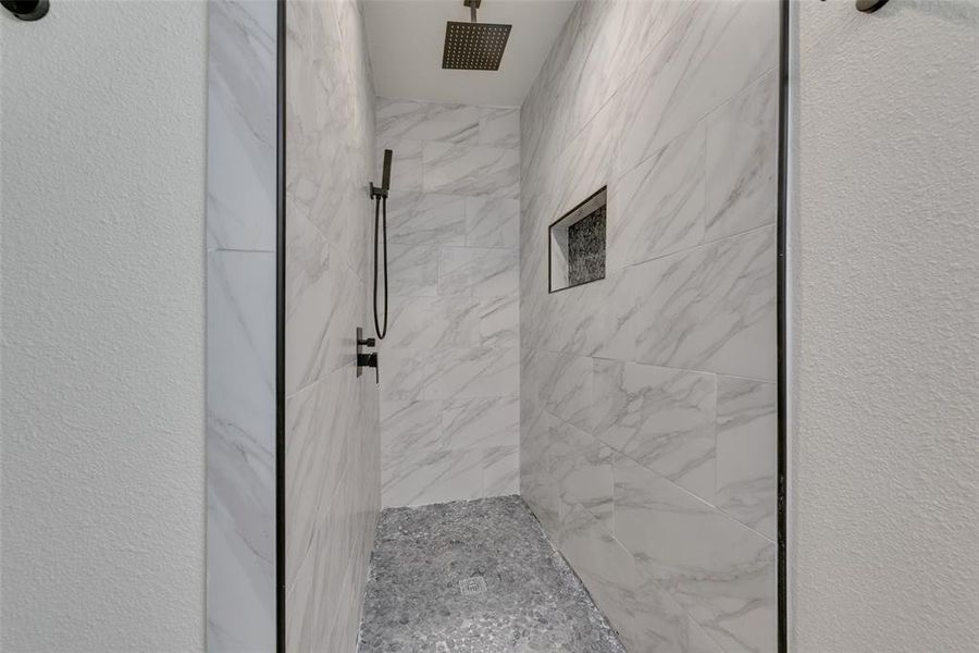 Bathroom featuring a tile shower