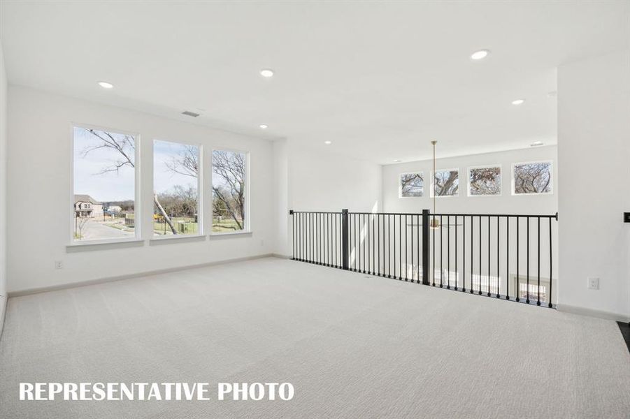 Open and airy, you'll find plenty of space for family fun in this outstanding game room!  REPRESENTATIVE PHOTO