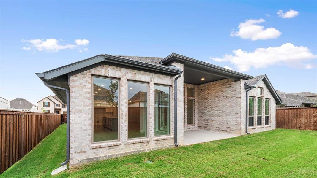 Back of house featuring a patio and a lawn