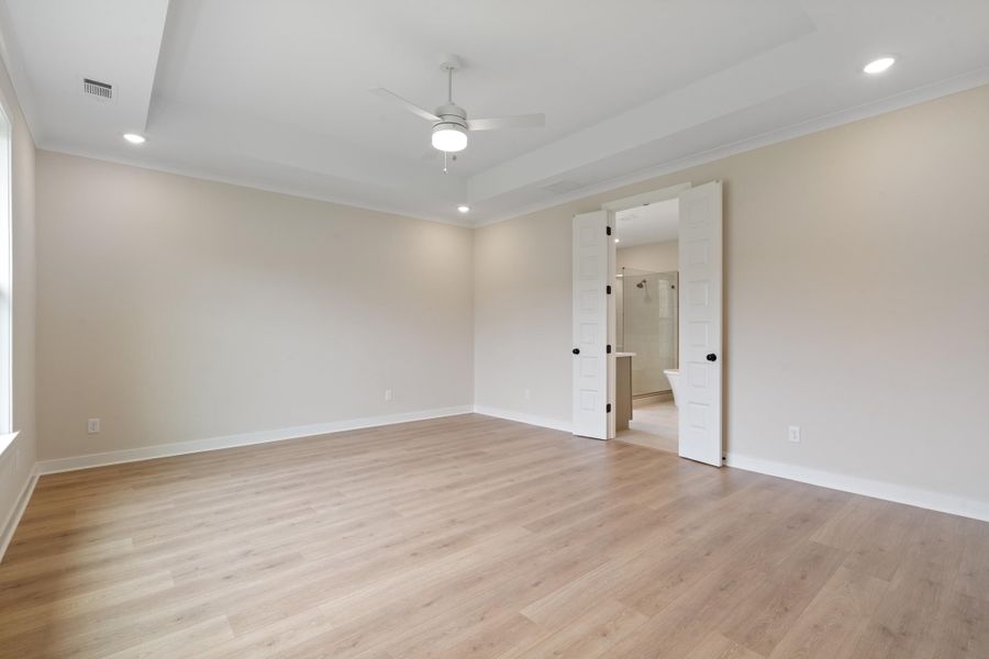 Recessed lighting, ceiling fan, crown molding, wood-finish flooring, and double barn doors Recessed lighting, ceiling fan, crown molding, wood-finish flooring, and double barn doors