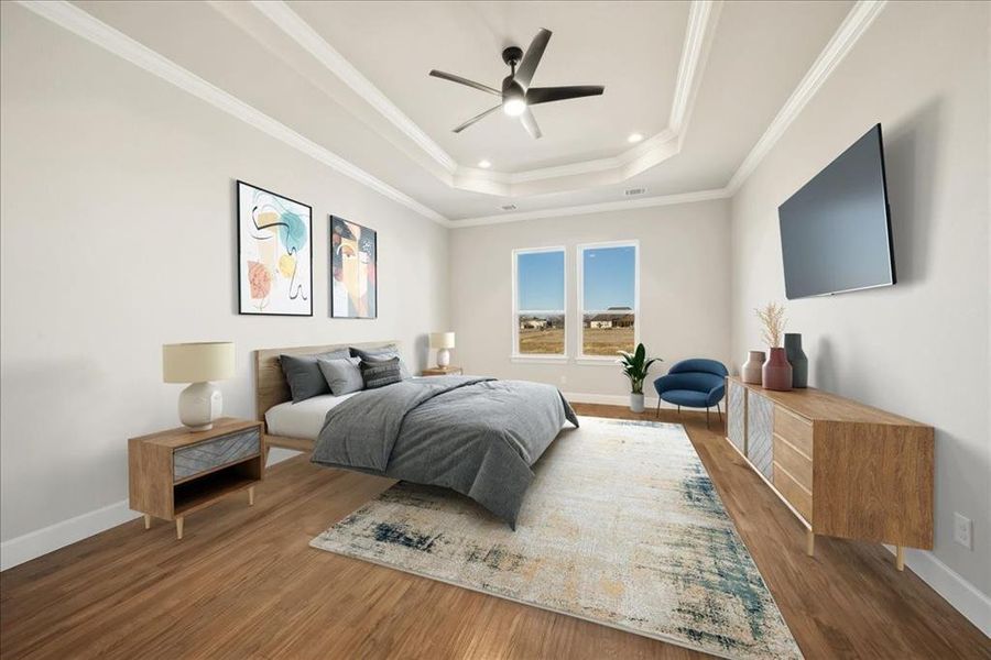 Bedroom with hardwood / wood-style floors, ornamental molding, a raised ceiling, and ceiling fan