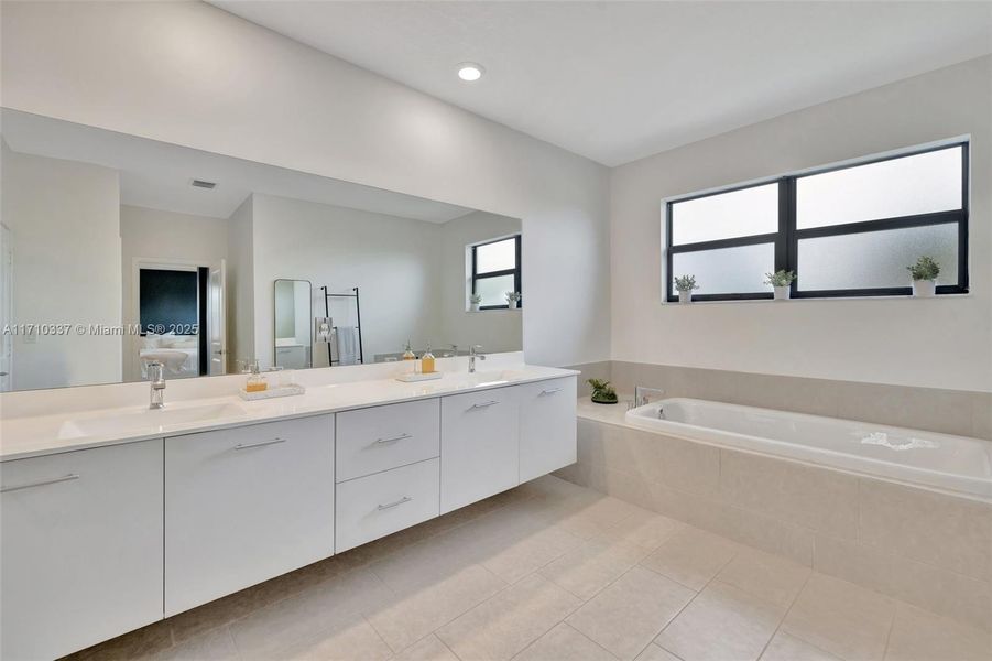 Primary Bathroom view toward oversized walk in shower and linen closet