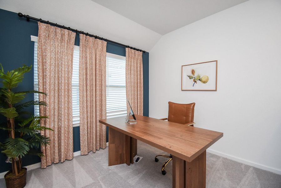 A dedicated office or study room with warm natural light and cozy furnishings