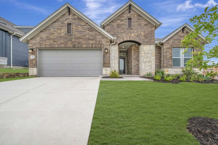 Front exterior of a new home in Sunfield, Buda, TX, highlighting curb appeal (Image 1). Front exterior of a new home in Sunfield, Buda, TX, highlighting curb appeal (Image 1).