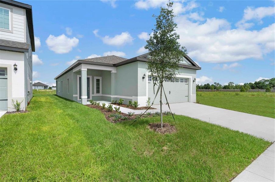 Front exterior of a new home in Gum Lake Preserve, Lake Alfred, FL, highlighting curb appeal (Image 16).