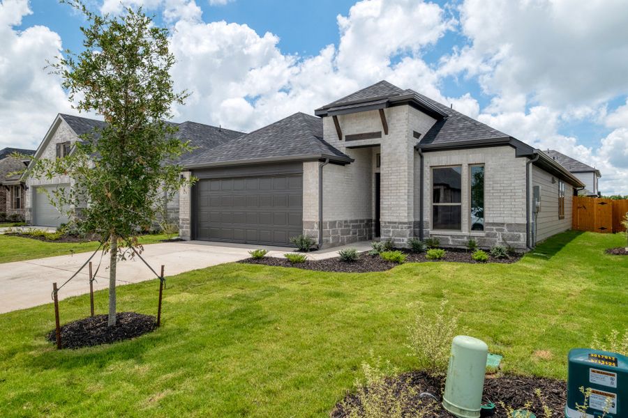 Front exterior of a new home in Prairie Winds, Hutto, TX, highlighting curb appeal (Image 2). Front exterior of a new home in Prairie Winds, Hutto, TX, highlighting curb appeal (Image 2).