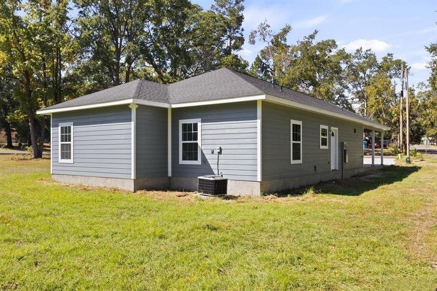 View of property exterior with a lawn