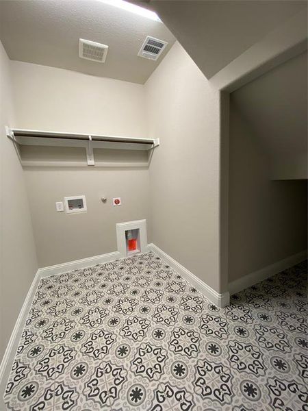 Utility room with extra storage under the stairs has custom decorative tile Utility room with extra storage under the stairs has custom decorative tile