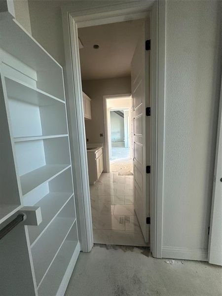 Primary closet conveniently connects to the utility room