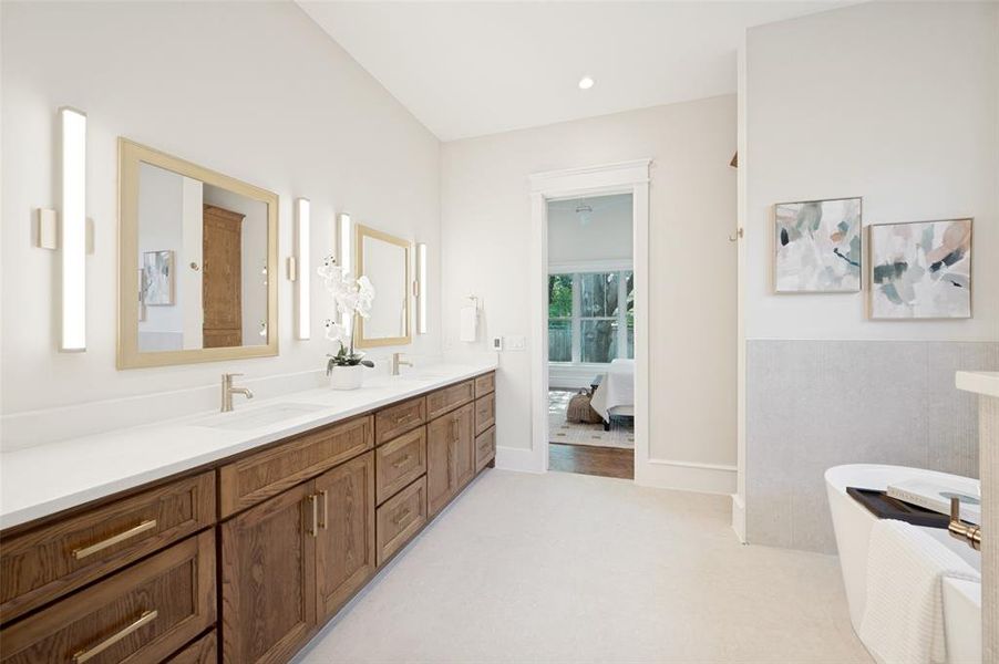 Dual vanity with wood-finish cabinetry and gold-tone hardware