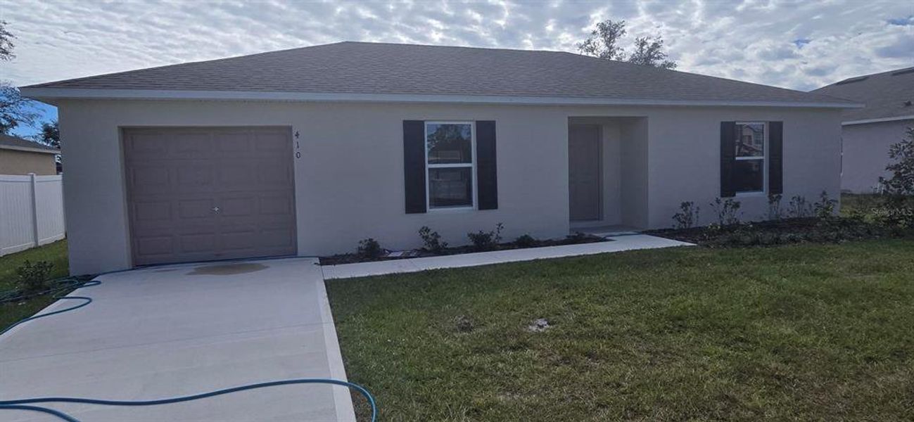 Front exterior of a new home in Poinciana, Poinciana, FL, highlighting curb appeal (Image 1). Front exterior of a new home in Poinciana, Poinciana, FL, highlighting curb appeal (Image 1).