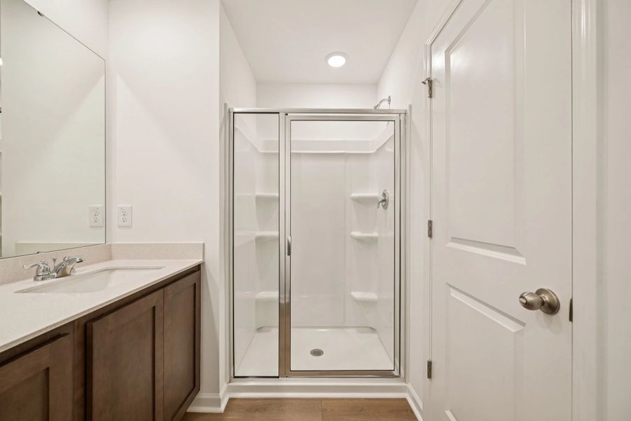 Primary Bath featuring the AW Collection® Roosevelt - Elegant tile and bold hardware finishes.