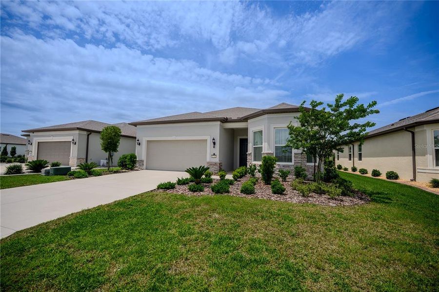 Front exterior of a new home in Del Webb Stone Creek, Ocala, FL, highlighting curb appeal (Image 25).