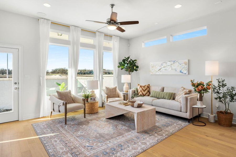 Living area with ceiling fan, wood finished floors, and recessed lighting Living area with ceiling fan, wood finished floors, and recessed lighting