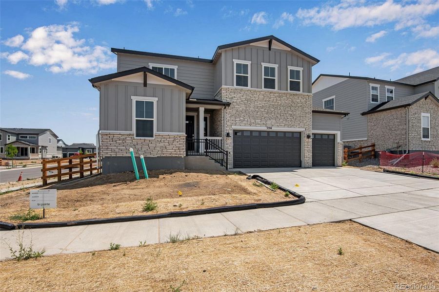 Front exterior of a new home in Ensemble at The Aurora Highlands, Aurora, CO, highlighting curb appeal (Image 23).