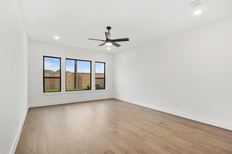 SAMPLE Roomy Main bedroom with hardwood floors