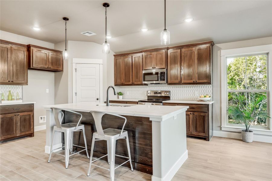 Gorgeous dark cabinetry with crown moulding finishings and refined footing