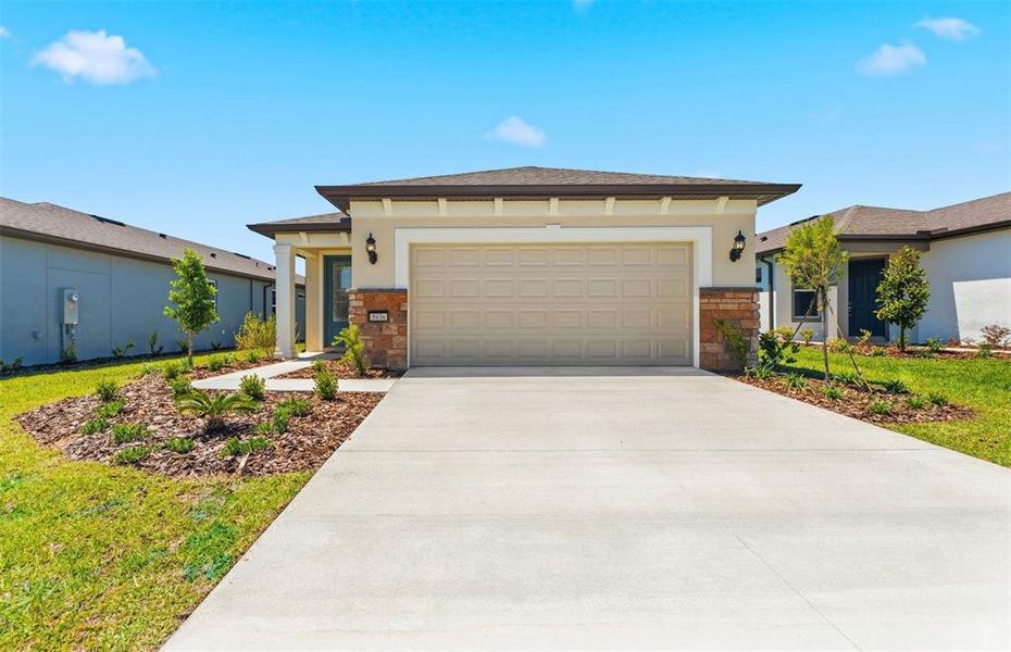 Front exterior of a new home in Del Webb Stone Creek, Ocala, FL, highlighting curb appeal (Image 1). Front exterior of a new home in Del Webb Stone Creek, Ocala, FL, highlighting curb appeal (Image 1).