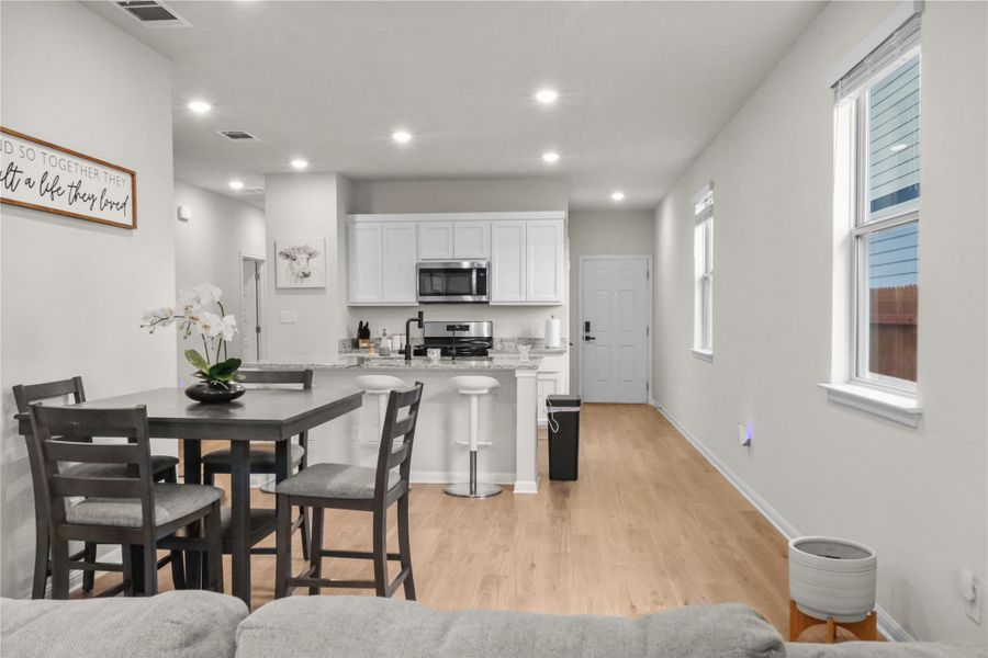 Dining room featuring light wood finished floors and recessed lighting