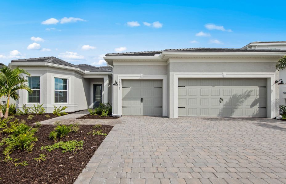 Front exterior of a new home in TerraWalk at Babcock Ranch, Alva, FL, highlighting curb appeal (Image 1). Front exterior of a new home in TerraWalk at Babcock Ranch, Alva, FL, highlighting curb appeal (Image 1).