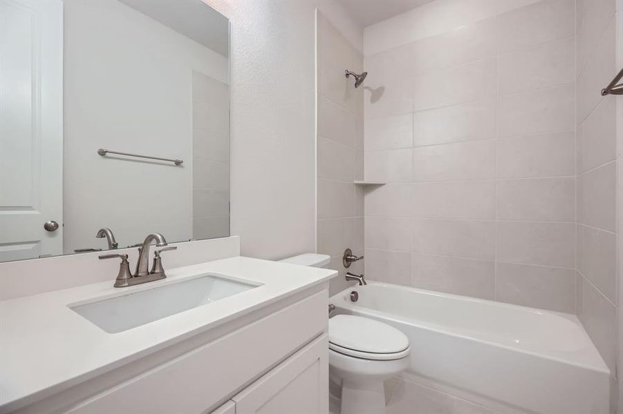 Full bathroom with vanity, tub / shower combination, and tile patterned flooring