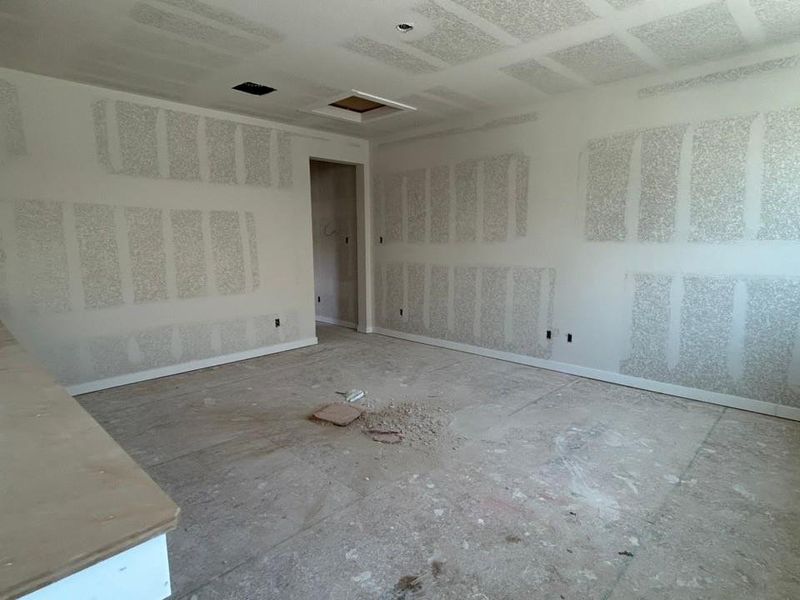 Unfurnished room featuring attic access