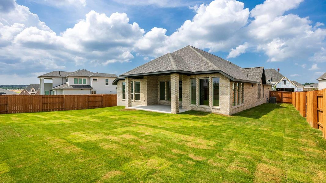 Back of property with roof with shingles, brick siding, a patio area, and central air condition unit