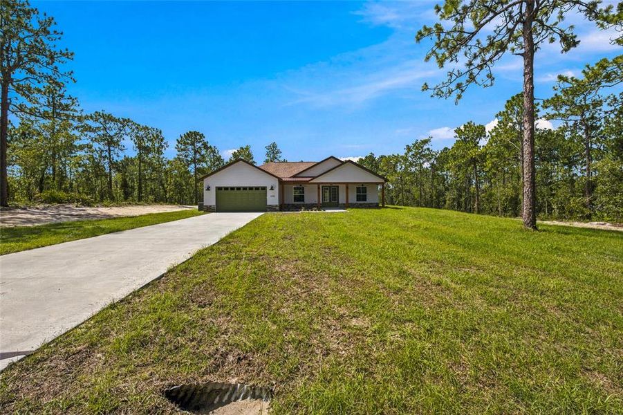 Front exterior of a new home in , Dunnellon, FL, highlighting curb appeal (Image 24).