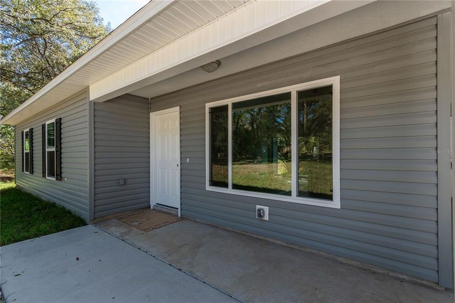 Front exterior of a new home in , Ocklawaha, FL, highlighting curb appeal (Image 11).