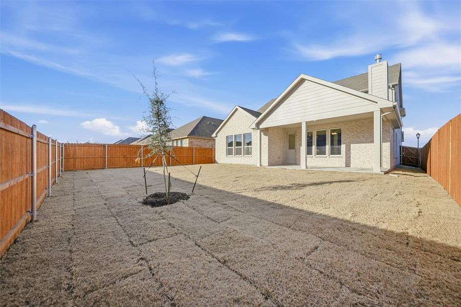 Rear view of property featuring a fenced backyard, a patio area, and a chimney Rear view of property featuring a fenced backyard, a patio area, and a chimney