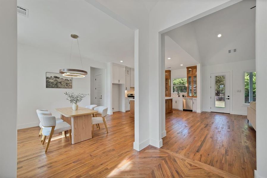 Dining area with light wood-style floors and recessed lighting Dining area with light wood-style floors and recessed lighting