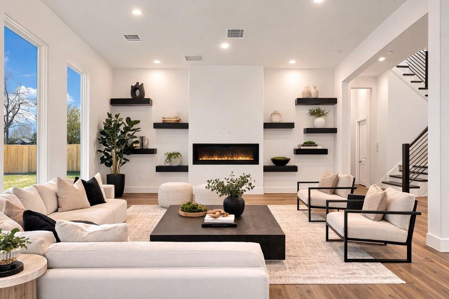 Virtually staged view of the living room with floating fireplace, shelves, open layout and tons of natural light Virtually staged view of the living room with floating fireplace, shelves, open layout and tons of natural light