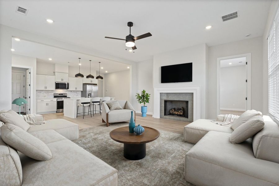 Open concept living area featuring wood-finish flooring and recessed lighting Open concept living area featuring wood-finish flooring and recessed lighting