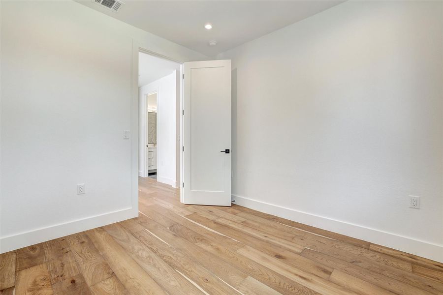 Empty room featuring baseboards and light wood-style floors