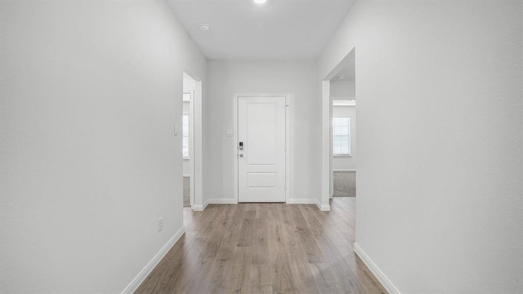 Hallway featuring baseboards and light wood-style flooring