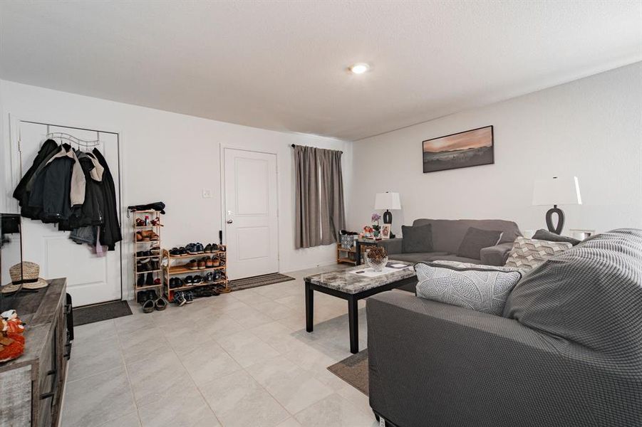 Living area featuring light tile patterned floors