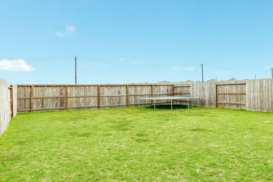 Exterior details and patio area of a home in Windrose Green, Angleton (Image 3).